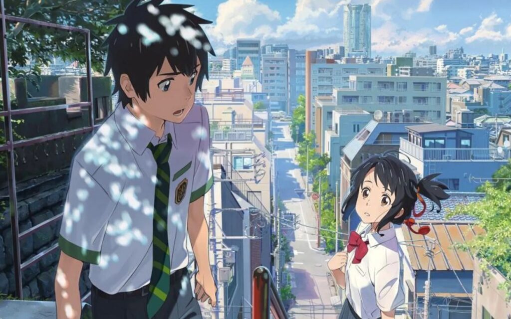 Escena de la película Your Name donde Taki y Mitsuha se encuentran en una calle de Tokio bajo la luz del día.